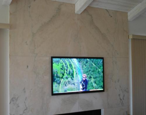 3. TV mounted to solid marble fireplace